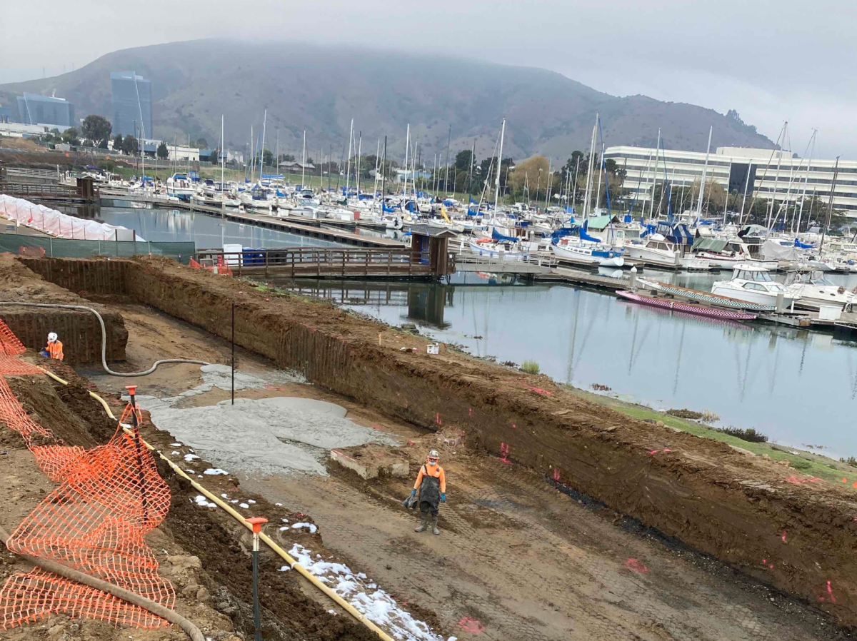 construction worker pouring cellular concrete near water in California